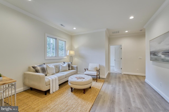 living room featuring light wood-type flooring and ornamental molding