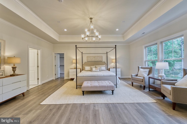 bedroom featuring crown molding, light hardwood / wood-style flooring, and a chandelier