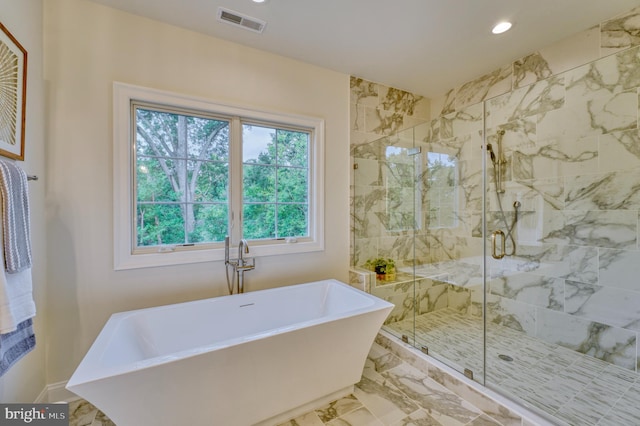 bathroom featuring separate shower and tub