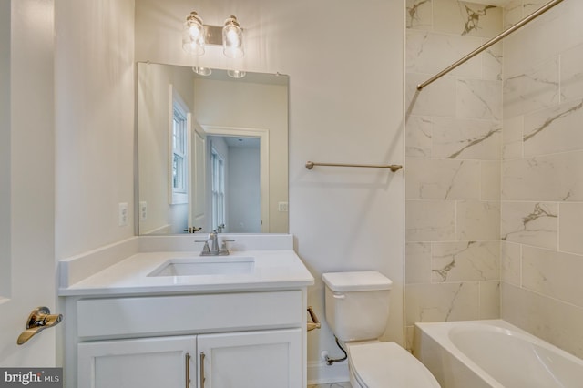 full bathroom with vanity, tiled shower / bath combo, and toilet