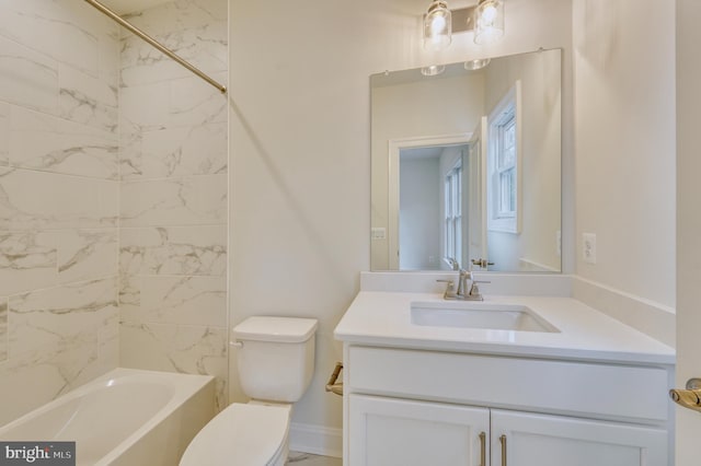 full bathroom featuring vanity, tiled shower / bath combo, and toilet