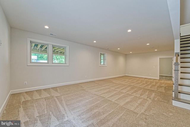 spare room with light colored carpet and a wealth of natural light