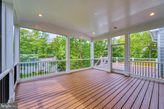 unfurnished sunroom featuring vaulted ceiling