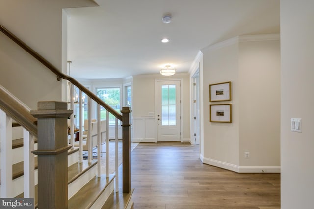 foyer entrance featuring light hardwood / wood-style flooring and ornamental molding