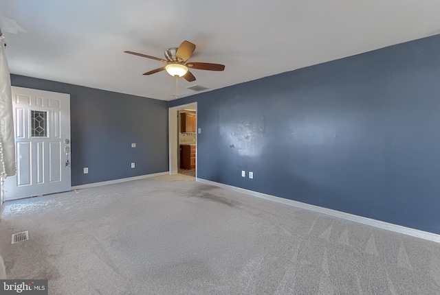 empty room with light carpet and ceiling fan