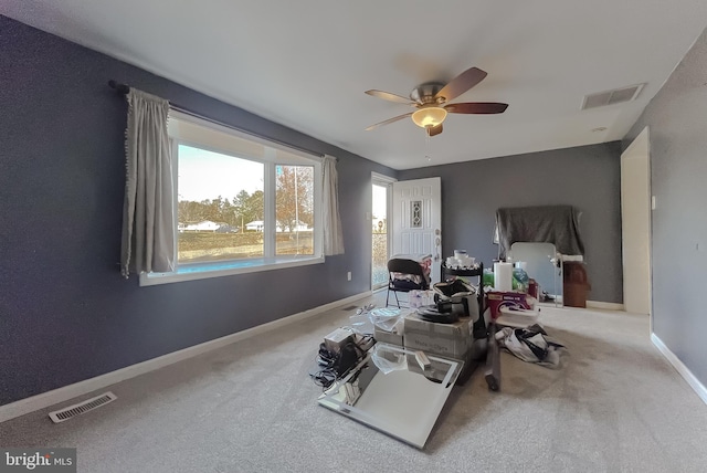 interior space featuring carpet flooring and ceiling fan