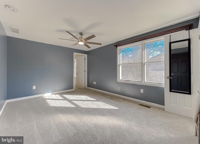 spare room featuring ceiling fan and light carpet