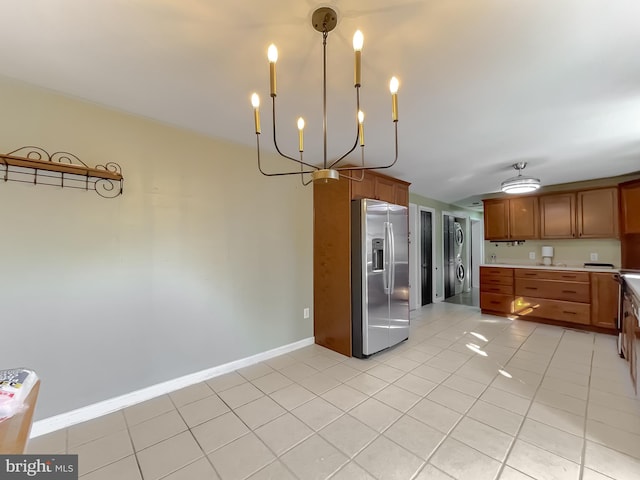 kitchen featuring light tile patterned flooring, decorative light fixtures, stainless steel refrigerator with ice dispenser, and an inviting chandelier