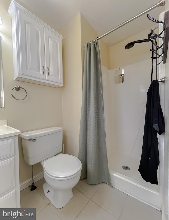 bathroom with tile patterned flooring, a shower with curtain, toilet, and vanity