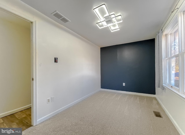 spare room with light colored carpet