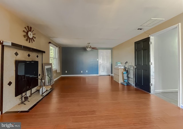 living room featuring hardwood / wood-style flooring and ceiling fan