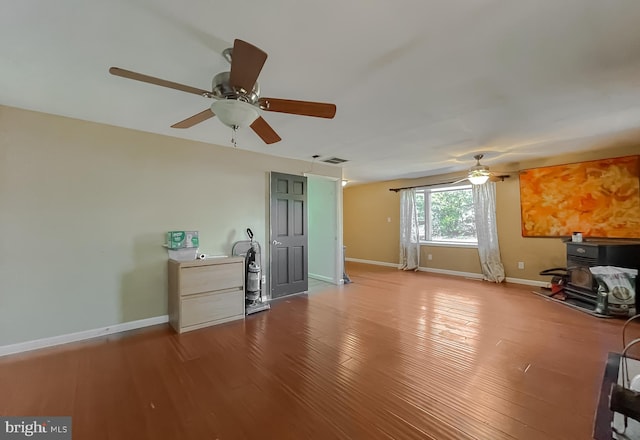 unfurnished living room featuring hardwood / wood-style flooring and ceiling fan