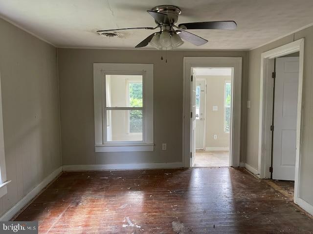 spare room featuring dark hardwood / wood-style flooring and ceiling fan