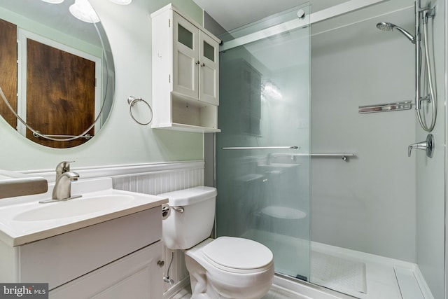 bathroom featuring vanity, an enclosed shower, and toilet