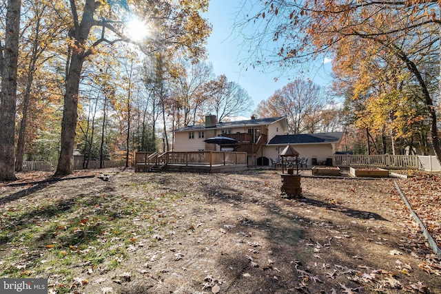 back of house featuring a wooden deck