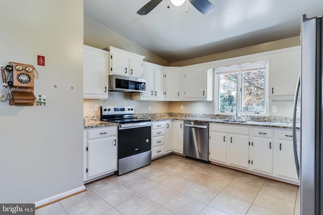 kitchen with sink, white cabinets, lofted ceiling, and appliances with stainless steel finishes