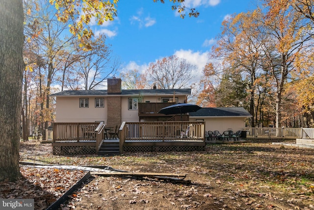 back of property featuring a deck