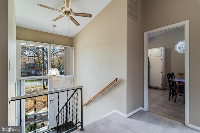 staircase with tile patterned flooring and ceiling fan