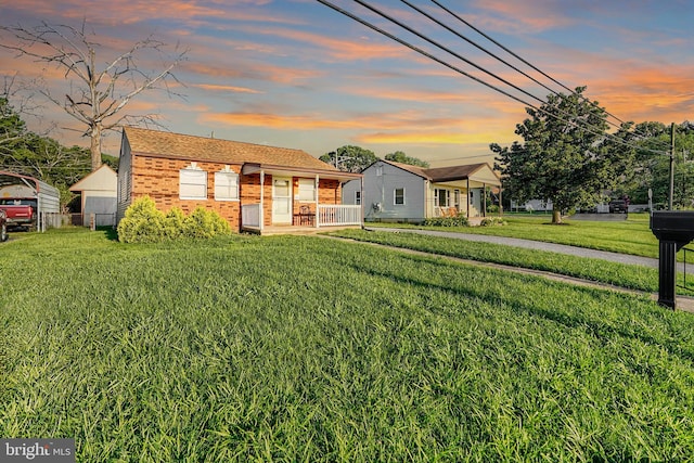 view of front of home featuring a yard and a porch