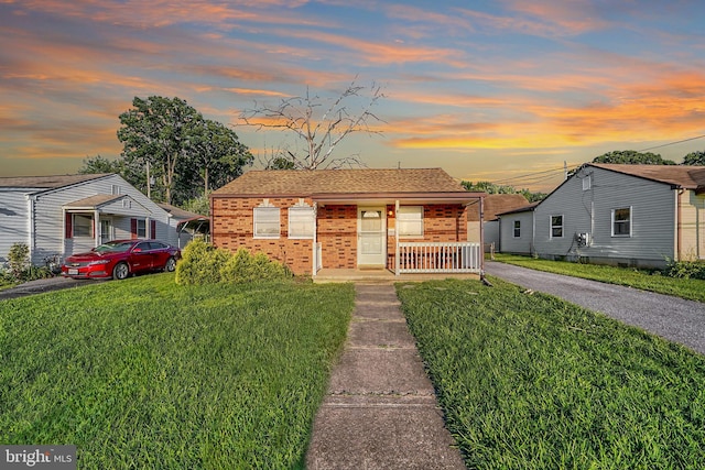 view of front of house featuring a yard and a porch