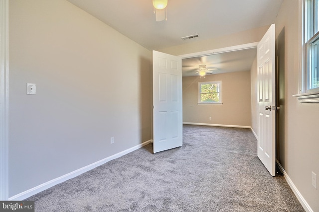 carpeted empty room featuring ceiling fan