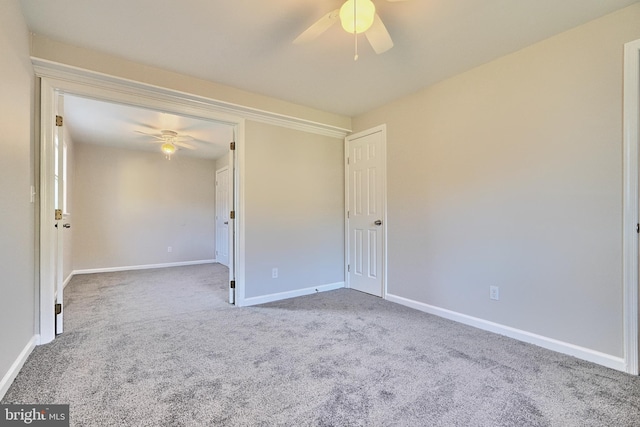 carpeted empty room featuring ceiling fan