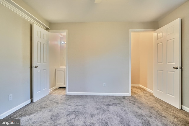 unfurnished bedroom featuring light carpet