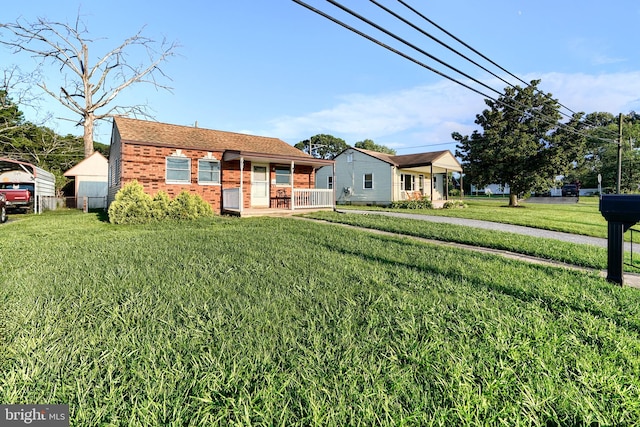 view of front of house with covered porch and a front lawn