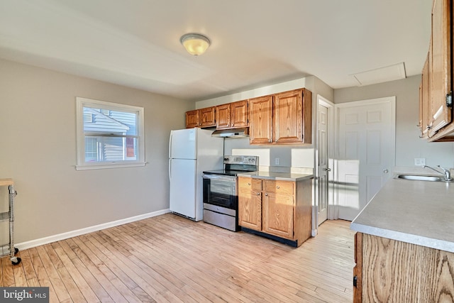 kitchen with sink, light hardwood / wood-style floors, white refrigerator, and electric stove