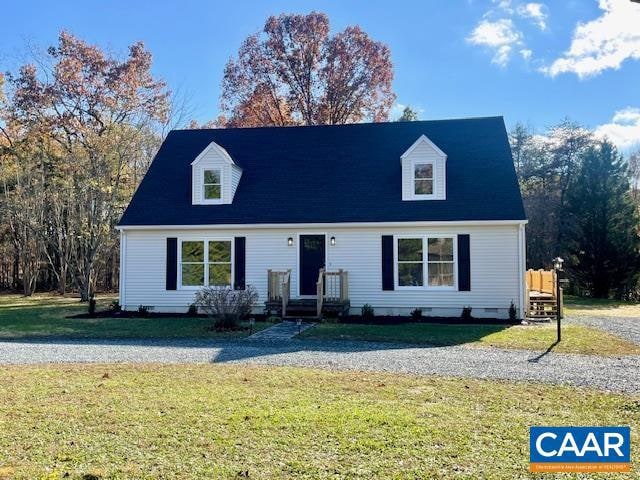 cape cod home with a front lawn