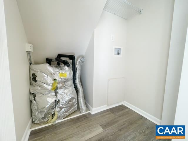 washroom with wood-type flooring and hookup for a washing machine