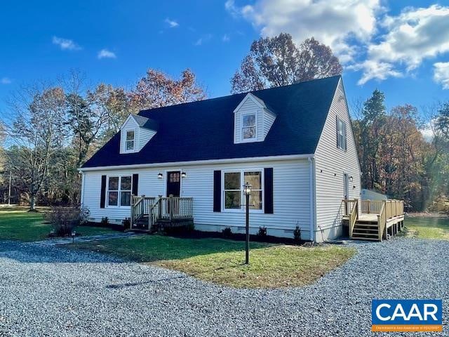 new england style home with a front yard and a deck