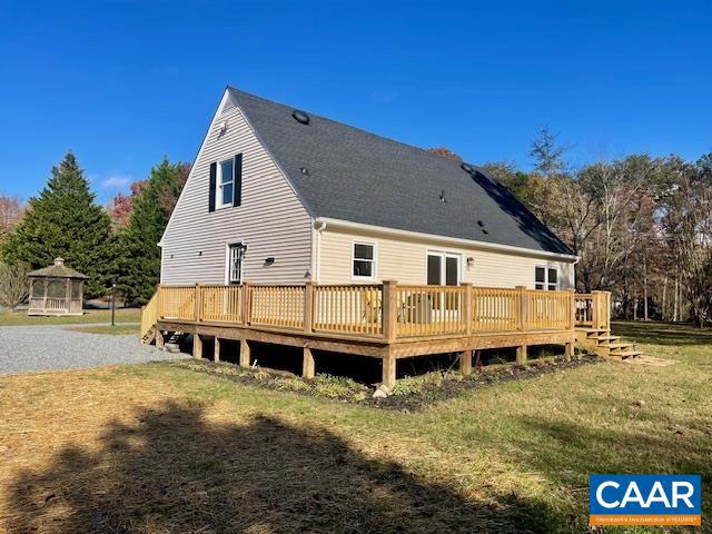 back of house with a gazebo, a yard, and a deck