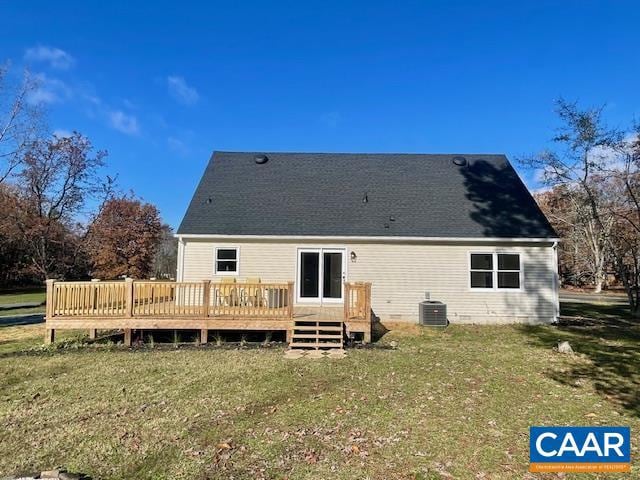 rear view of property featuring a yard, a wooden deck, and central air condition unit