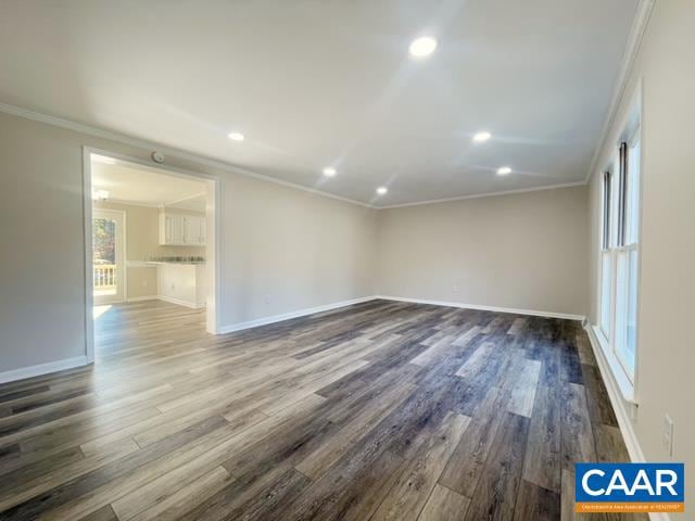 empty room with crown molding and dark hardwood / wood-style floors