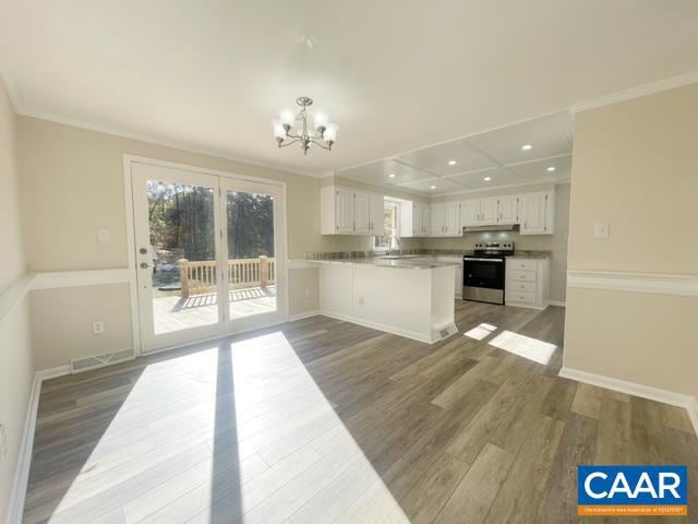 kitchen with kitchen peninsula, dark hardwood / wood-style flooring, stainless steel range with electric stovetop, crown molding, and white cabinetry