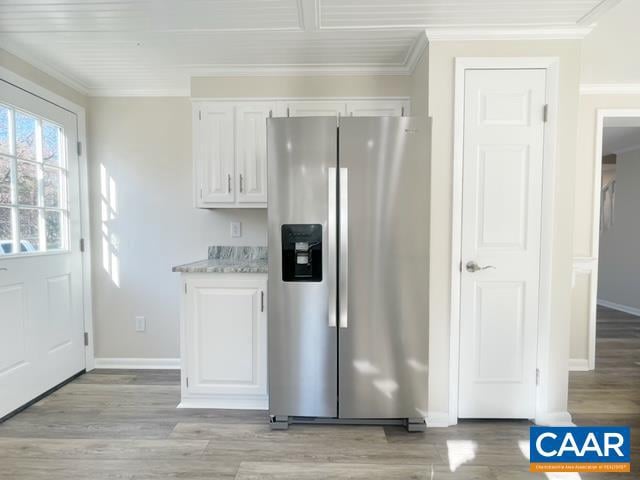 kitchen featuring white cabinets, stainless steel refrigerator with ice dispenser, and light hardwood / wood-style flooring