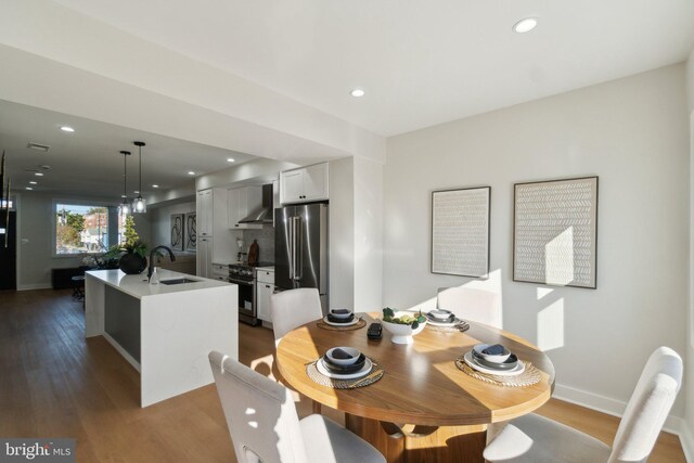 dining room featuring sink and hardwood / wood-style floors