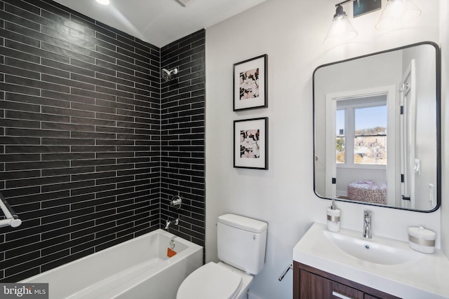 full bathroom with vanity, toilet, and tiled shower / bath