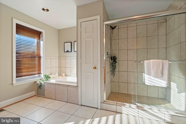 bathroom featuring tile patterned flooring and shower with separate bathtub