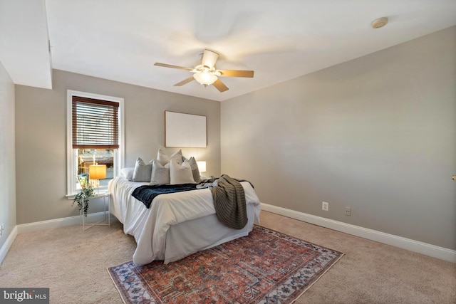 bedroom featuring ceiling fan and light colored carpet