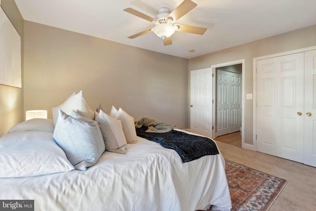 bedroom with ceiling fan and light colored carpet