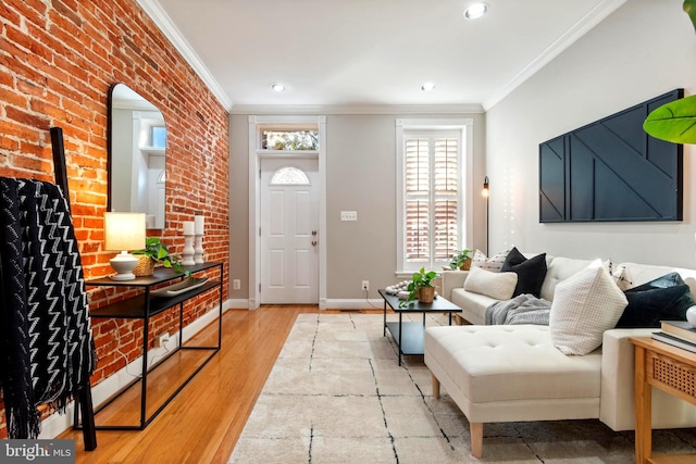 foyer with light hardwood / wood-style floors, crown molding, and brick wall