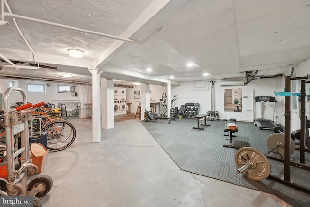 gym featuring a wall mounted AC