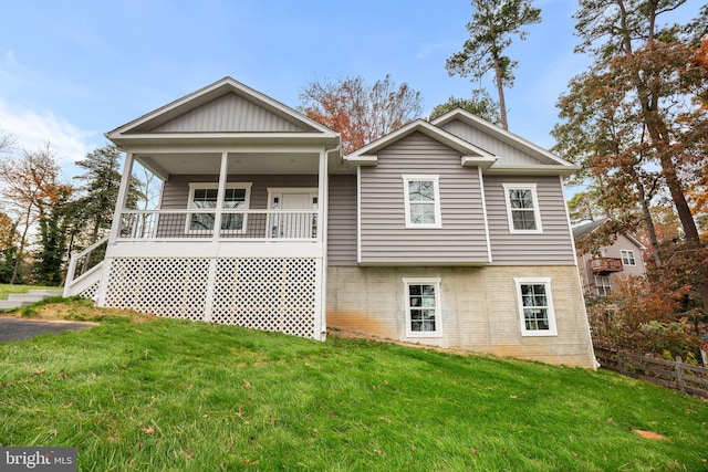 back of house featuring a yard and a porch