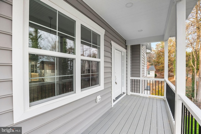 wooden terrace featuring covered porch