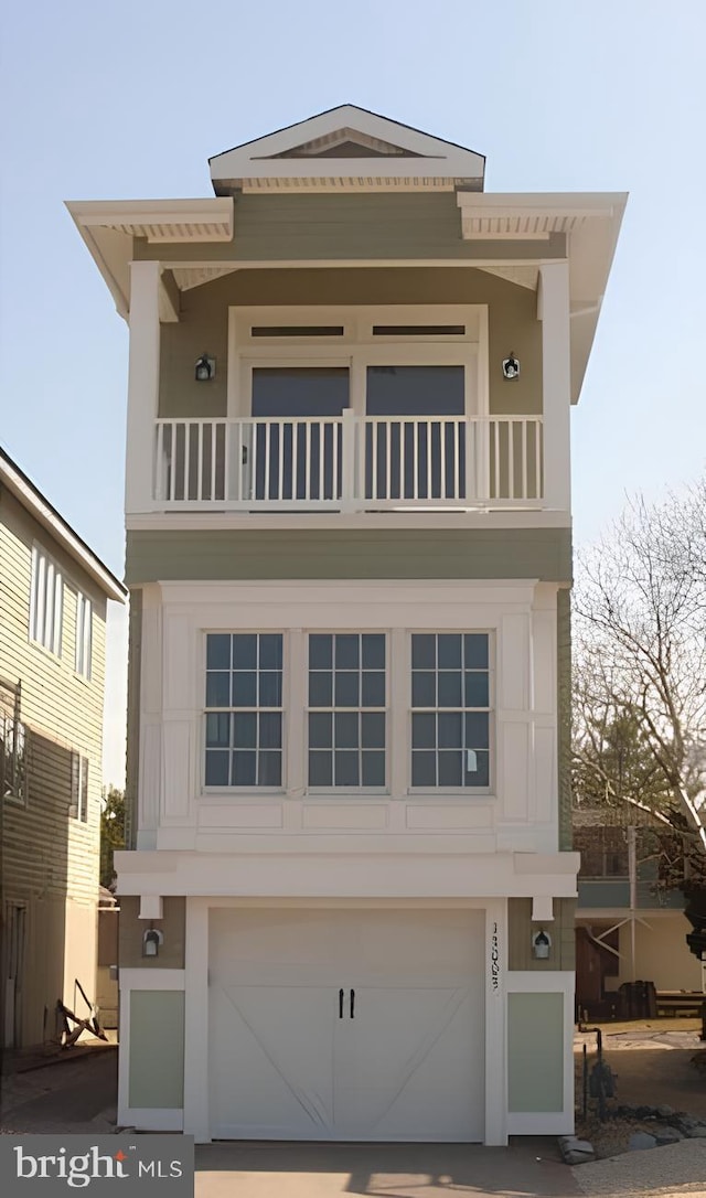 view of front of home with a balcony and a garage