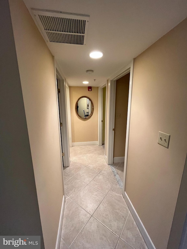 hall featuring light tile patterned flooring