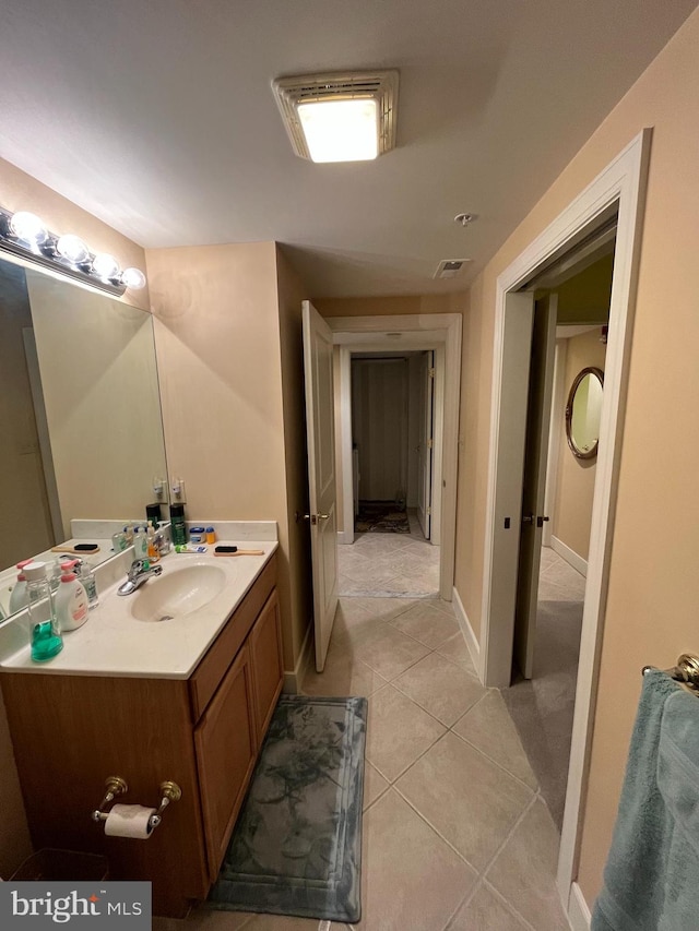 bathroom with tile patterned floors and vanity