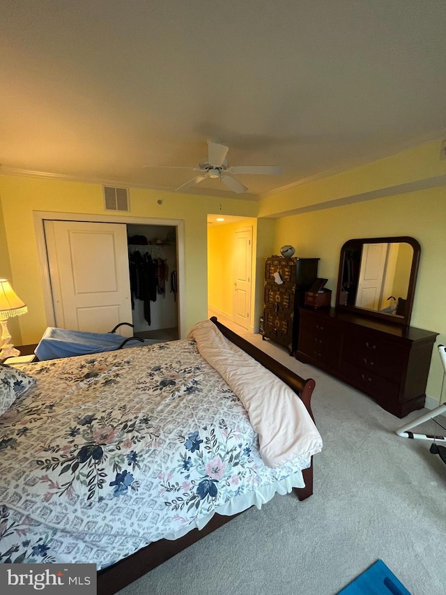 carpeted bedroom featuring ceiling fan and a closet